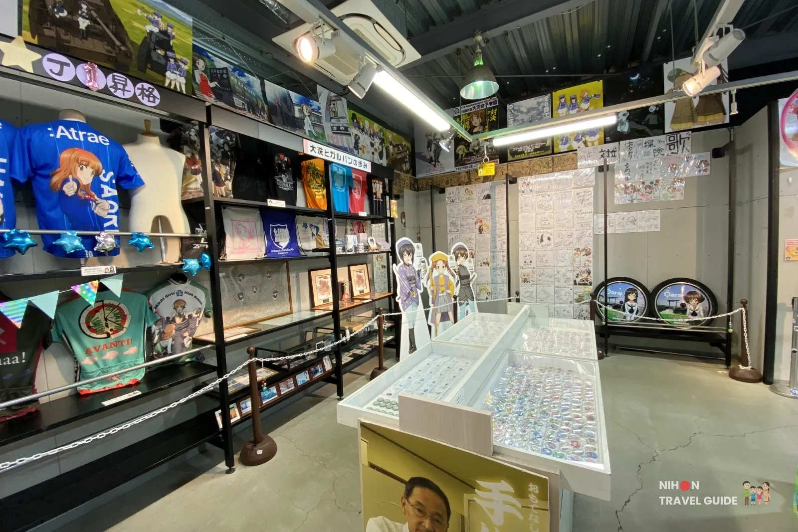 Girls und Panzer t-shirts and display of badges at Oarai Garupan Gallery.