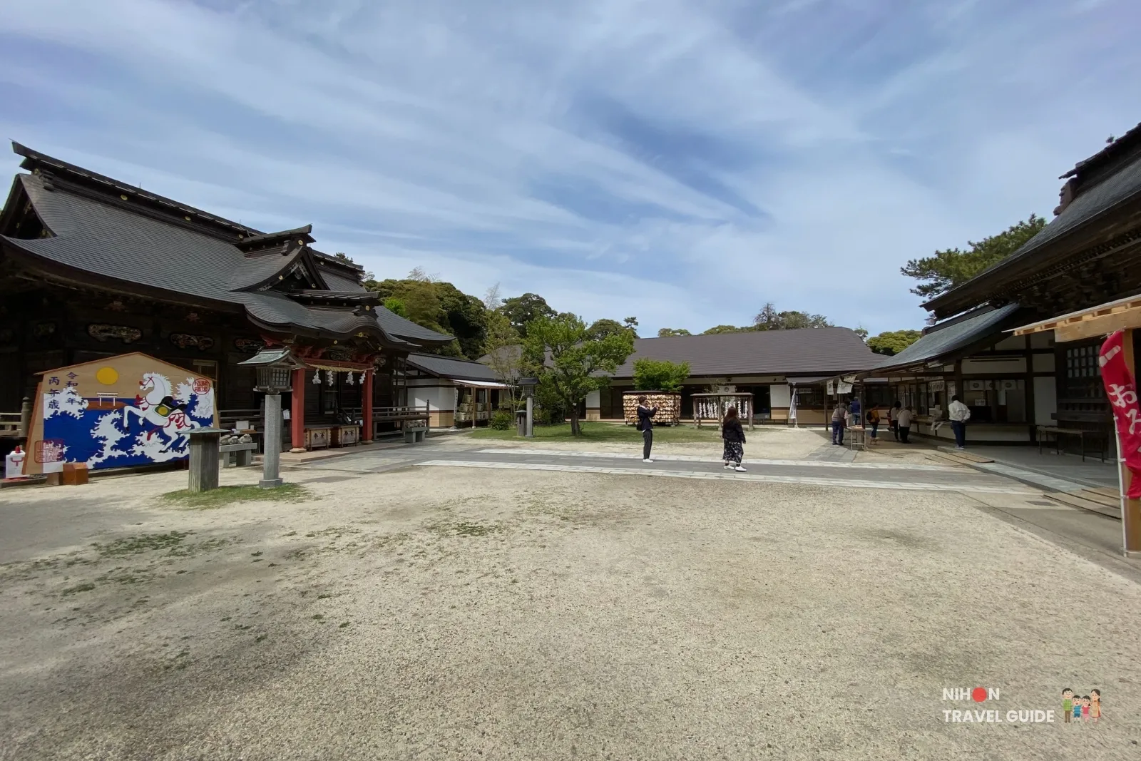 Spacious shrine courtyard with traditional buildings under a blue sky at Oarai Isosaki Shrine in Ibaraki, Japan
