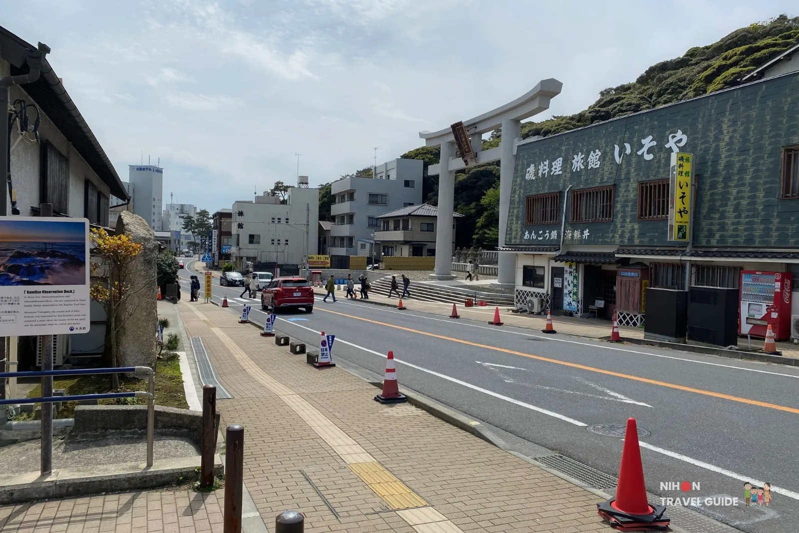 Street view showing the large torii gate and shops near Oarai Isosaki Shrine in Ibaraki, Japan