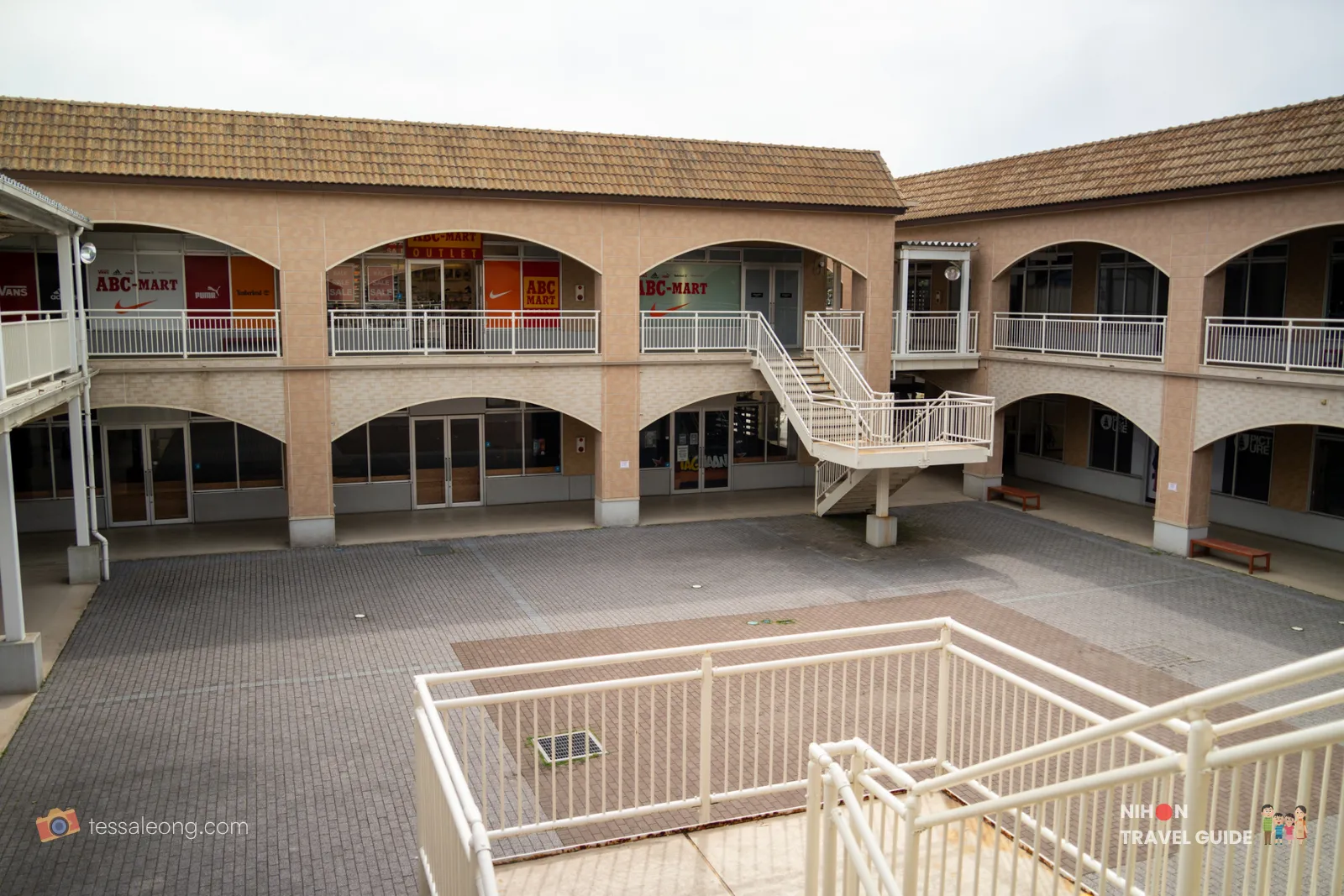 Upper level view of Oarai Seaside Station courtyard showing ABC-Mart outlet and white staircase in Ibaraki