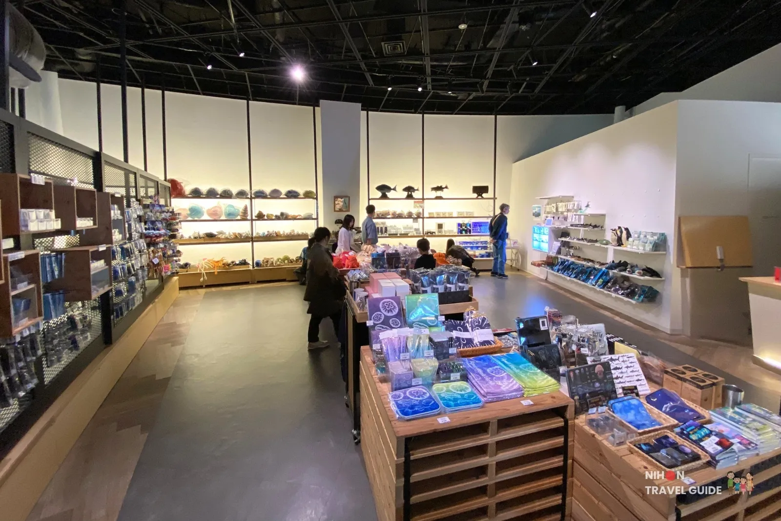 Interior of the Collector’s Shop Galeos gift shop at Aqua World Ibaraki Oarai Aquarium, showing shelves of souvenirs, plush toys, and marine-themed merchandise with visitors browsing