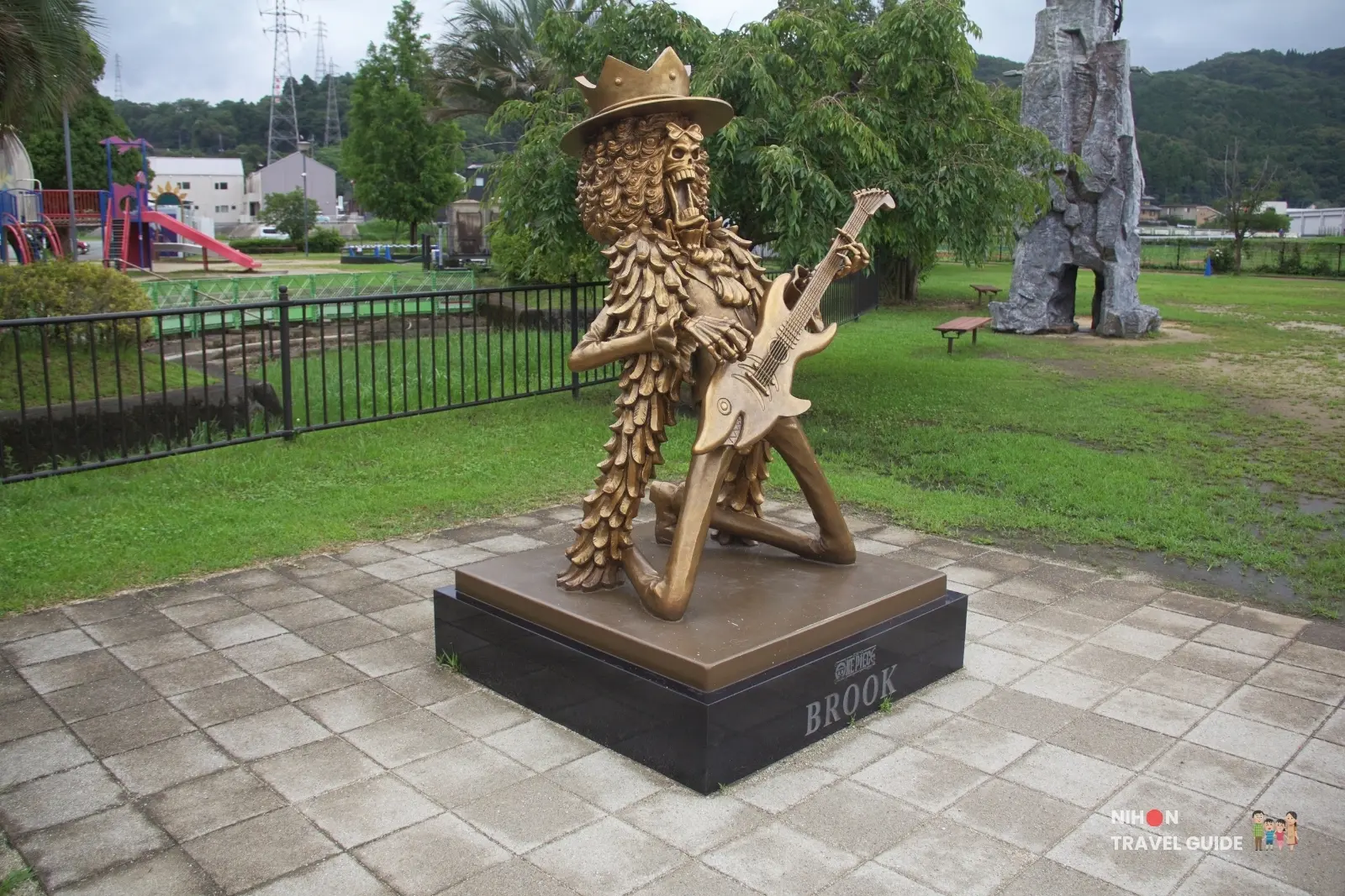 Side view of the large bronze Brook statue from One Piece at Mifune Fureai Park Dinosaur Park in Kumamoto, Japan.