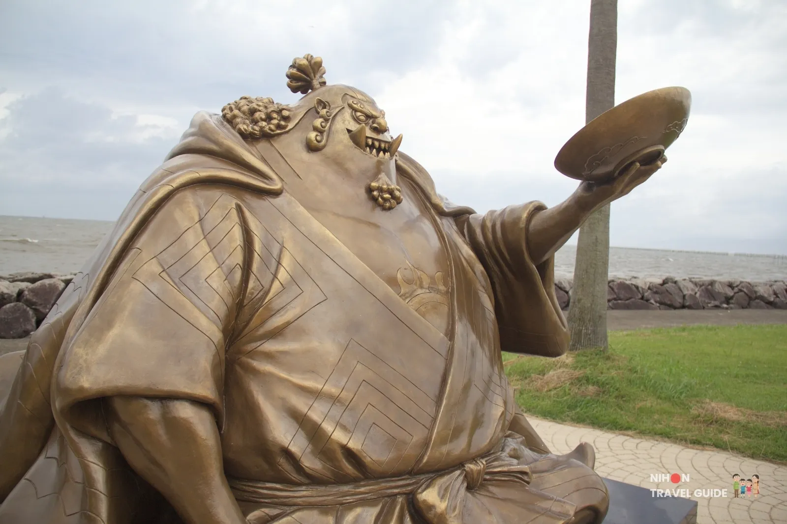 Close-up of the bronze Jinbe statue from One Piece holding a large bowl at Sumiyoshi Seaside Park in Kumamoto, Japan