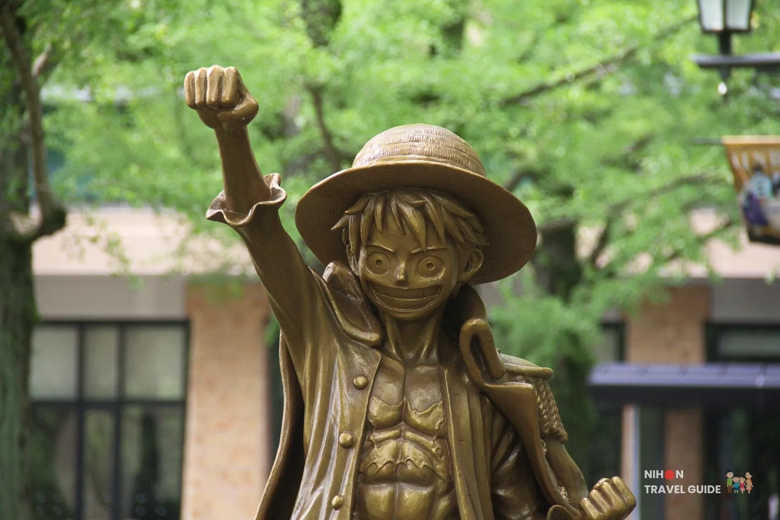 Close-up of the bronze Monkey D. Luffy statue from One Piece with fist raised at Kumamoto Prefectural Government Office.