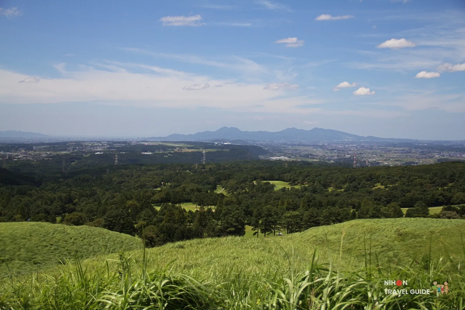 Scenic view from Mount Omine and Takayuhara Plateau observation point overlooking the Aso region with Mount Omine in the distance in Kumamoto.