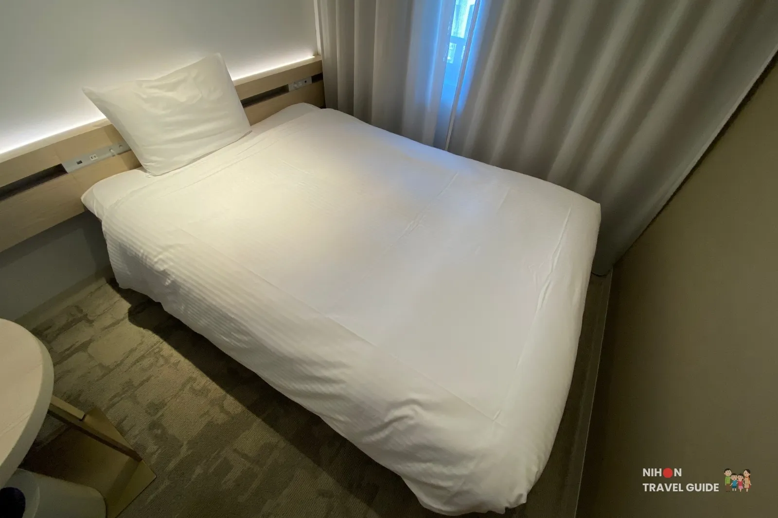 140 cm semi-double bed with soft lighting and headboard in the Single Room with Shower Booth at REF Kumamoto by Vessel Hotels.