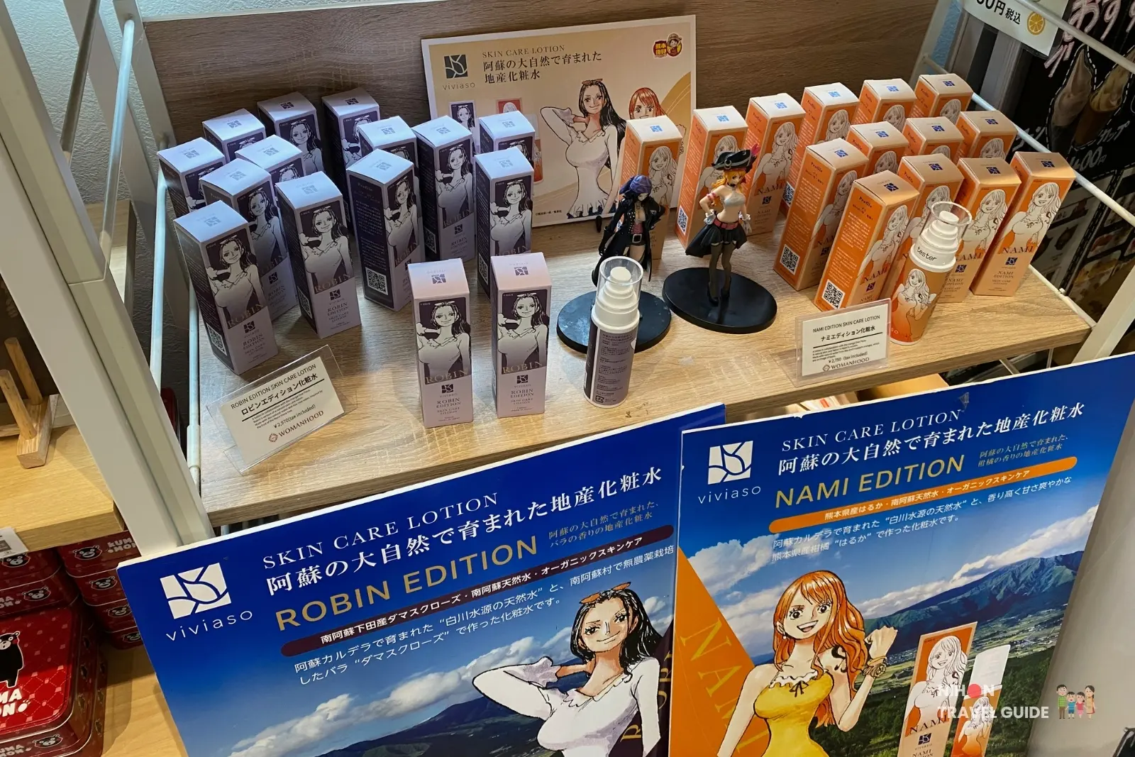 Robin and Nami edition Viviaso skin care lotions and One Piece figurines on display at OKAGESAMA MOBA near the Jinbe statue in Kumamoto.