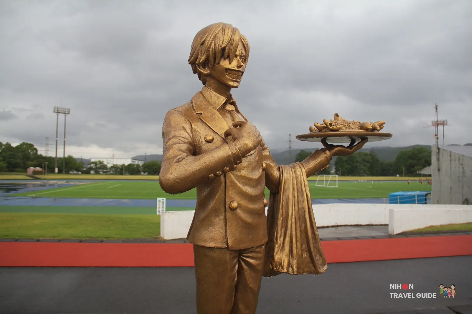 Bronze Sanji statue from One Piece standing by the running track at Mashiki Town General Gymnasium and Sports Park in Kumamoto.