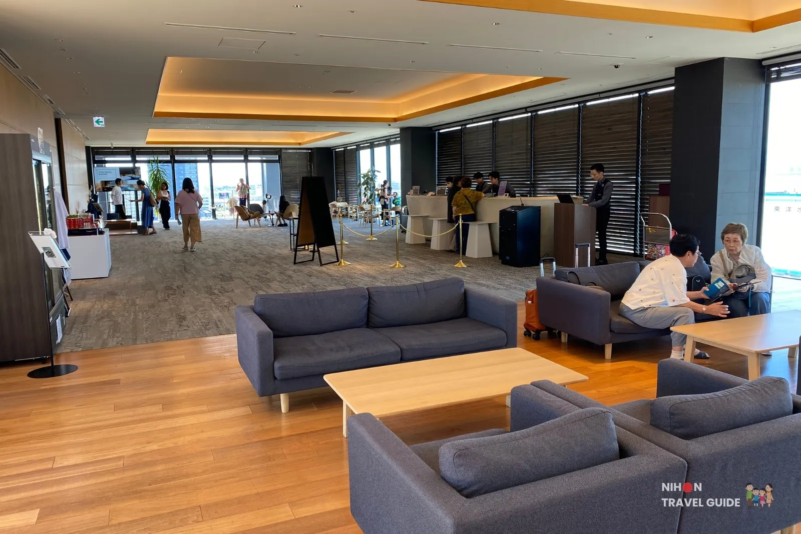 the358-sora-11f-check-in-lounge 11th floor check-in desk and guest lounge at The358 SORA Fukuoka, with sofas in the foreground and reception beyond.