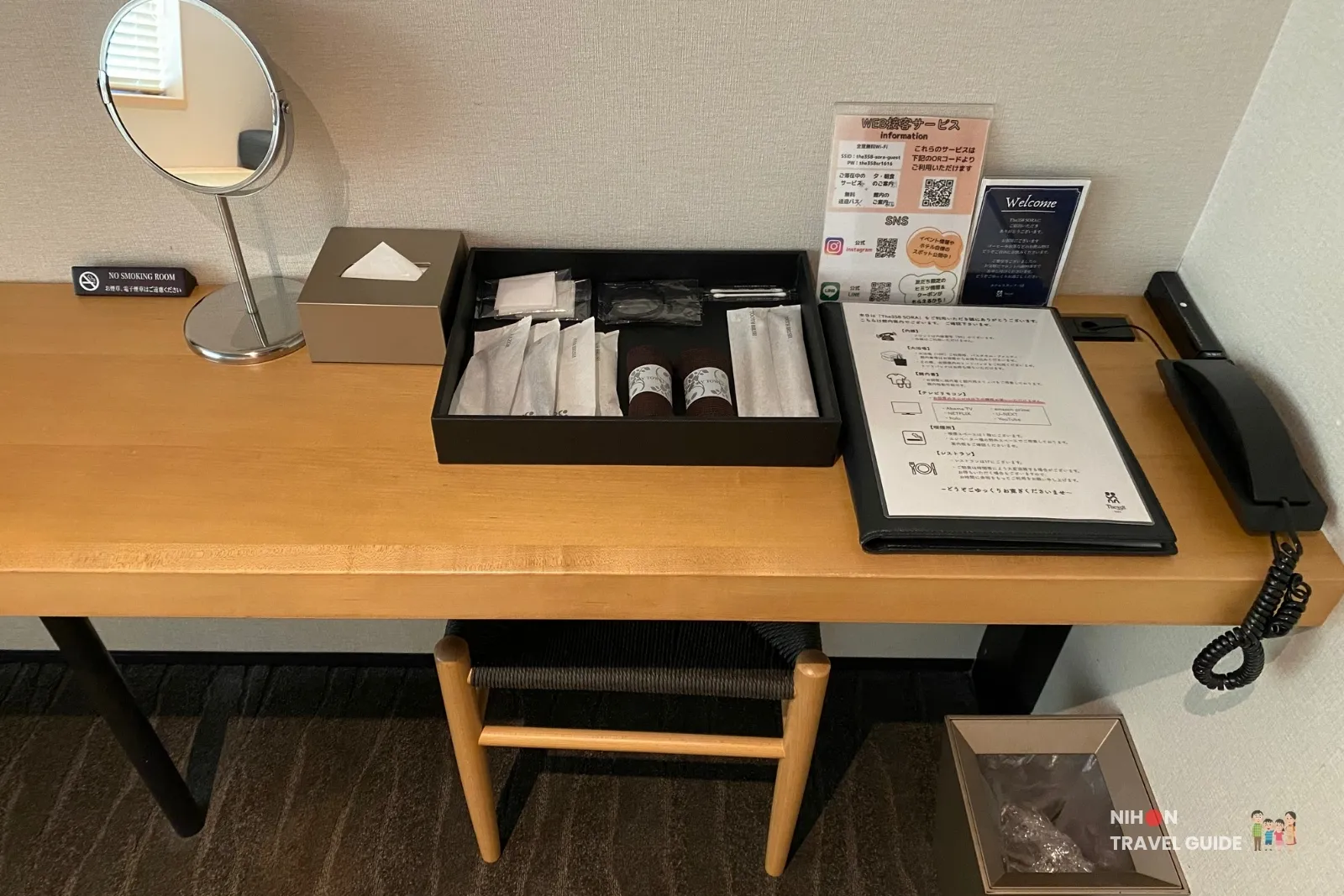 Desk in The358 SORA Modern Japanese Premium Room with amenity tray, welcome folder and room phone
