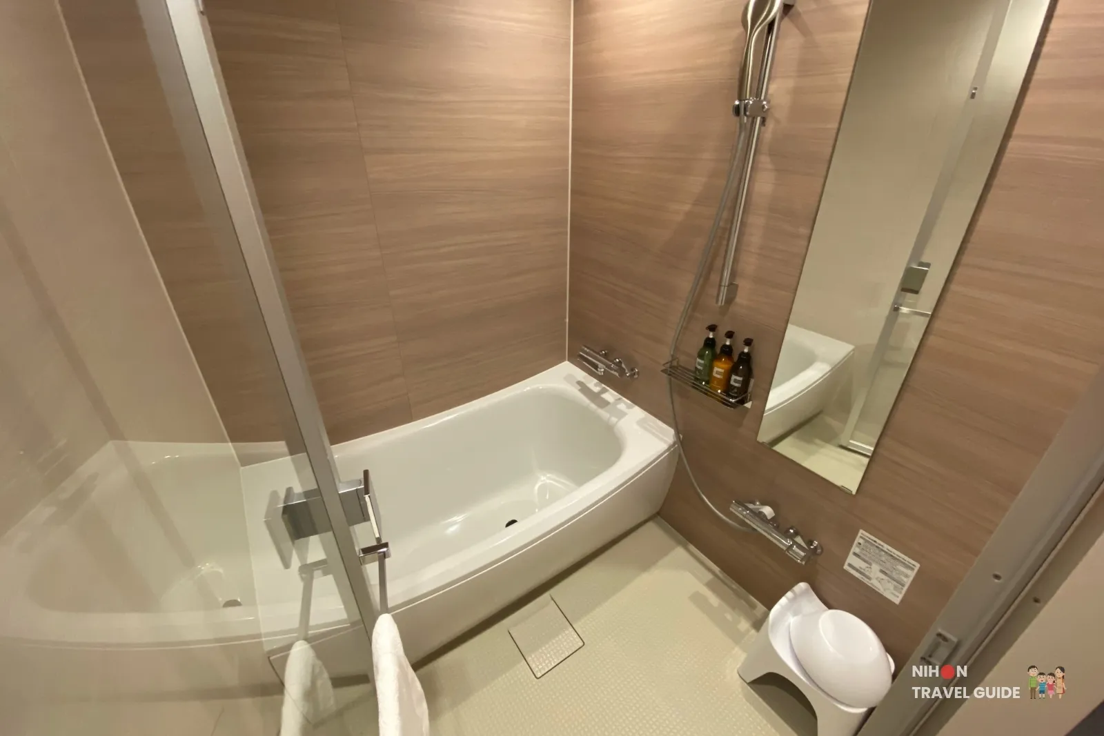 Full-size tub, handheld shower and full-length mirror in the Modern Japanese Premium bathroom at The358 SORA