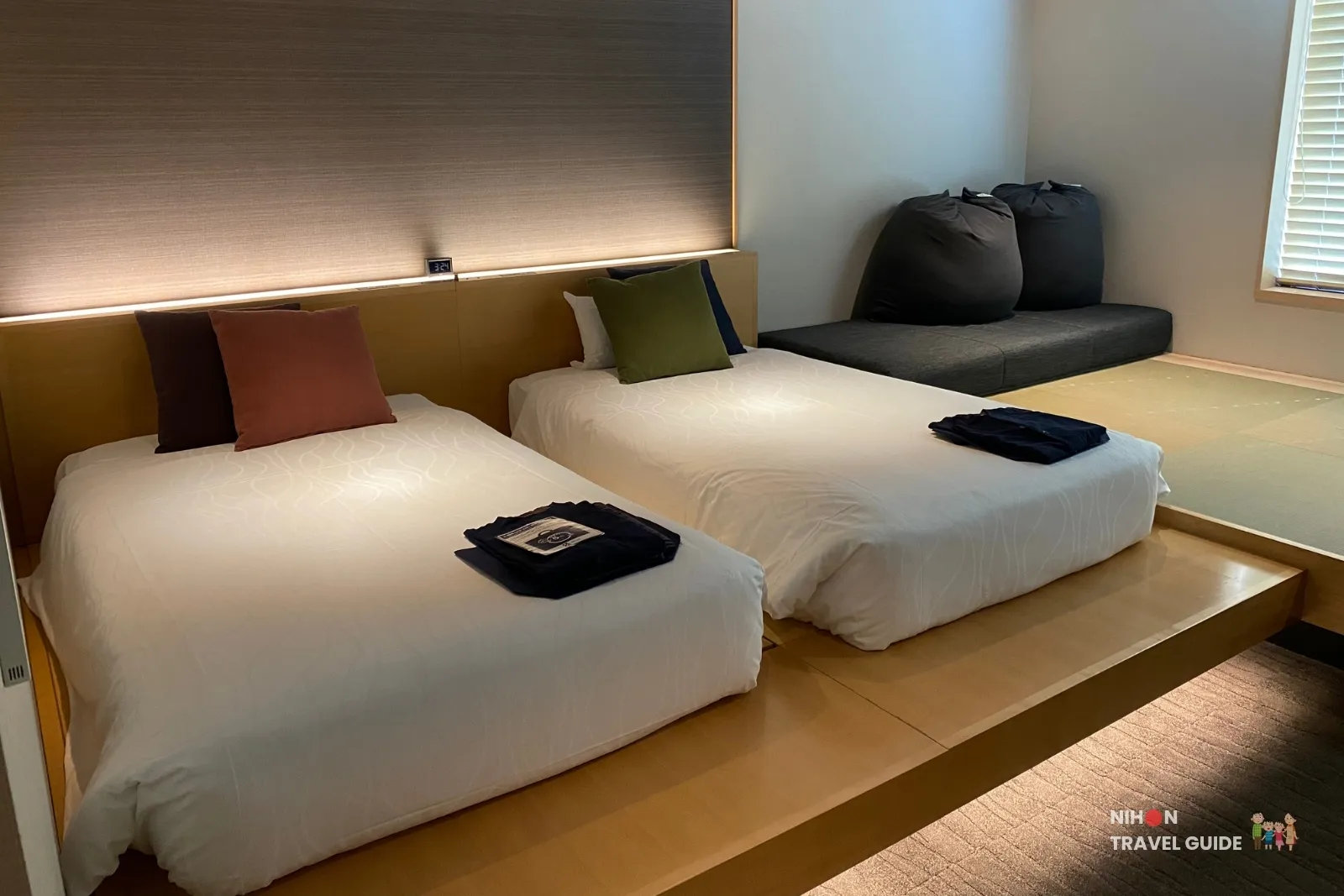 Twin beds on the koagari platform with yukata folded on top in The358 SORA Modern Japanese Premium Room.