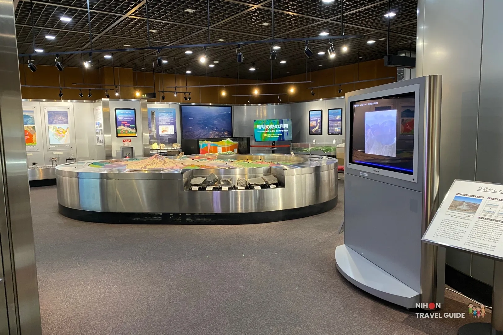 tsukuba-geological-museum-exhibition-room-3-mt-fuji-model Exhibition Room 3 at the Tsukuba Geological Museum featuring the large 3D topographic model of Mt. Fuji and surrounding volcanoes, with displays on geothermal energy and soil liquefaction.