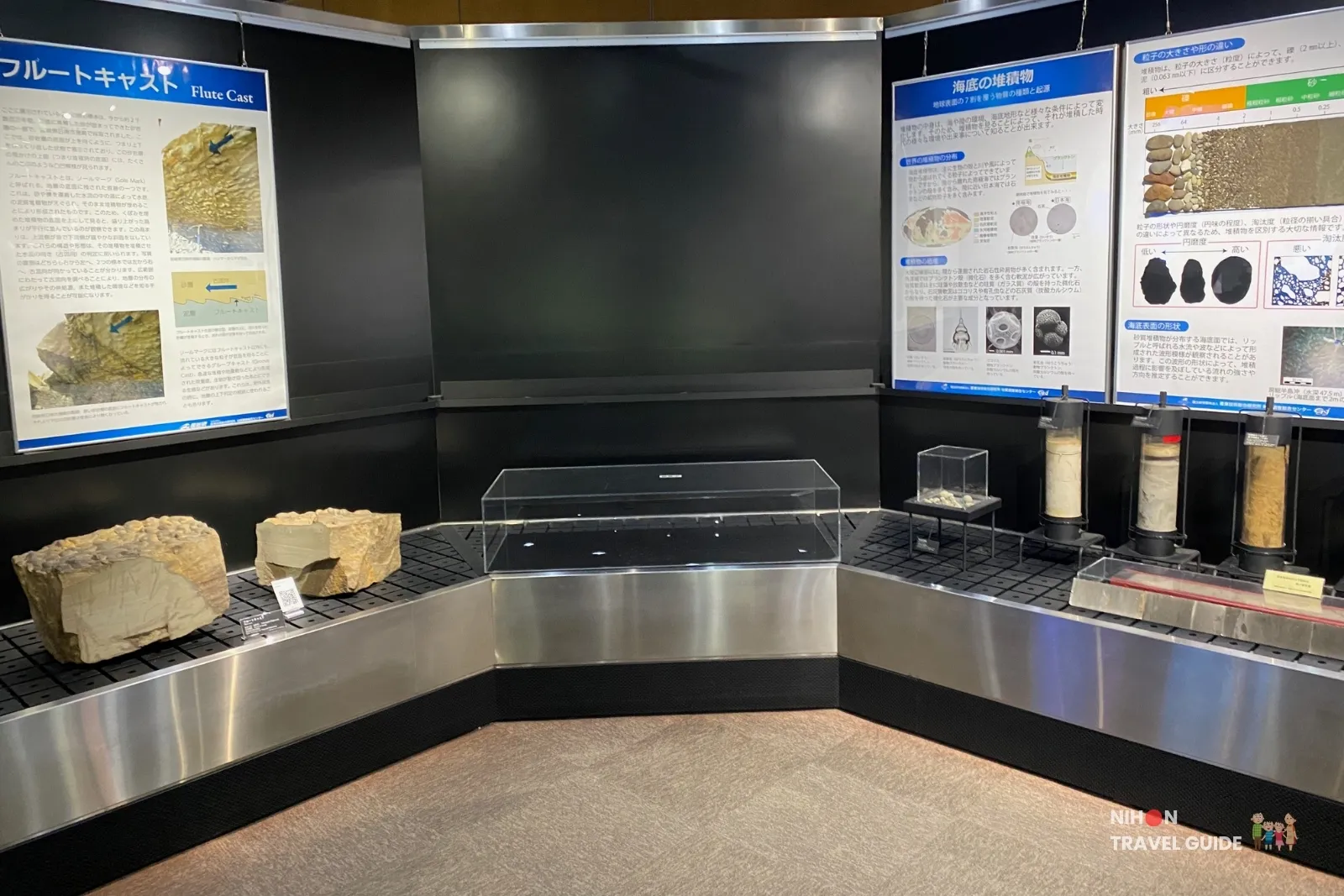 Corner display in Exhibition Room 2 showing flute cast sedimentary structures and seafloor sediment samples with educational panels at the Tsukuba Geological Museum.
