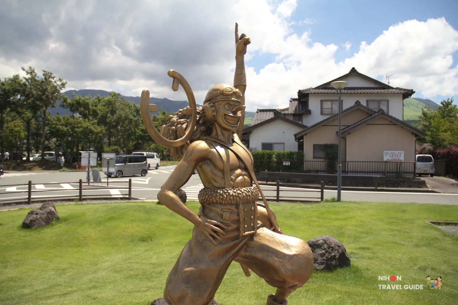 Close-up of the bronze Usopp statue from One Piece pointing to the sky at Aso Station in Kumamoto.