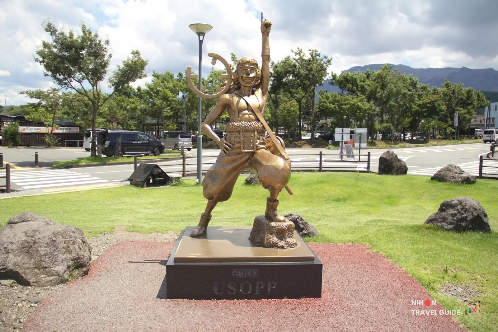 Full front view of the bronze Usopp statue from One Piece at Aso Station in Kumamoto.