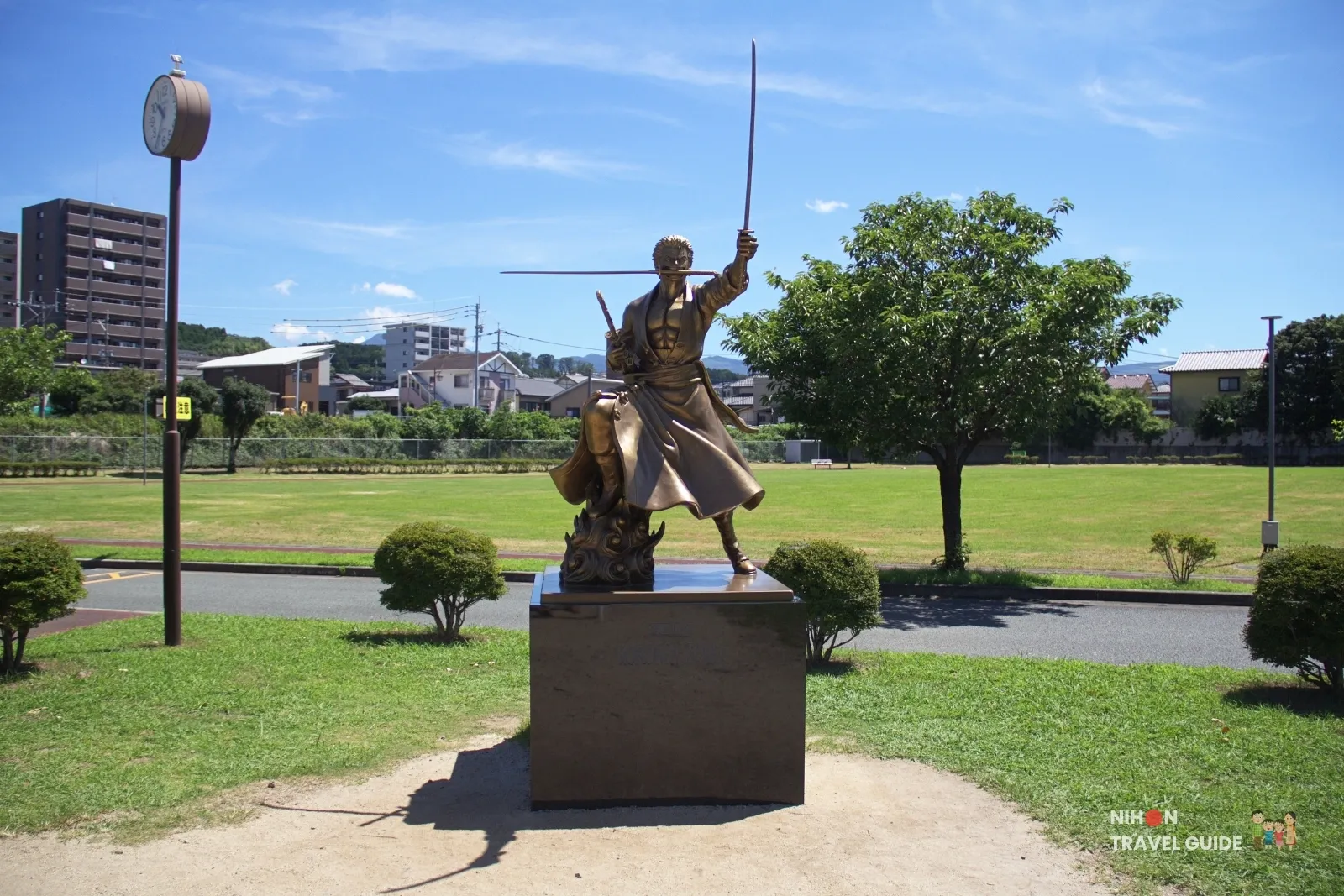 Full front view of the bronze Roronoa Zoro statue from One Piece at Ozu Central Park in Kumamoto.