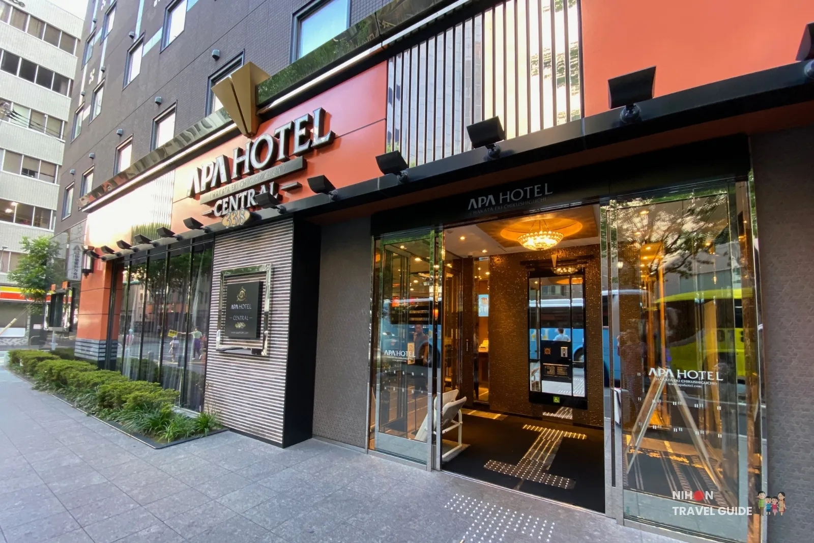 APA Hotel Hakata Eki Chikushiguchi Central building entrance on Hakata-eki Higashi, with the orange facade, “CENTRAL 338” sign, and glass doors into the lobby.