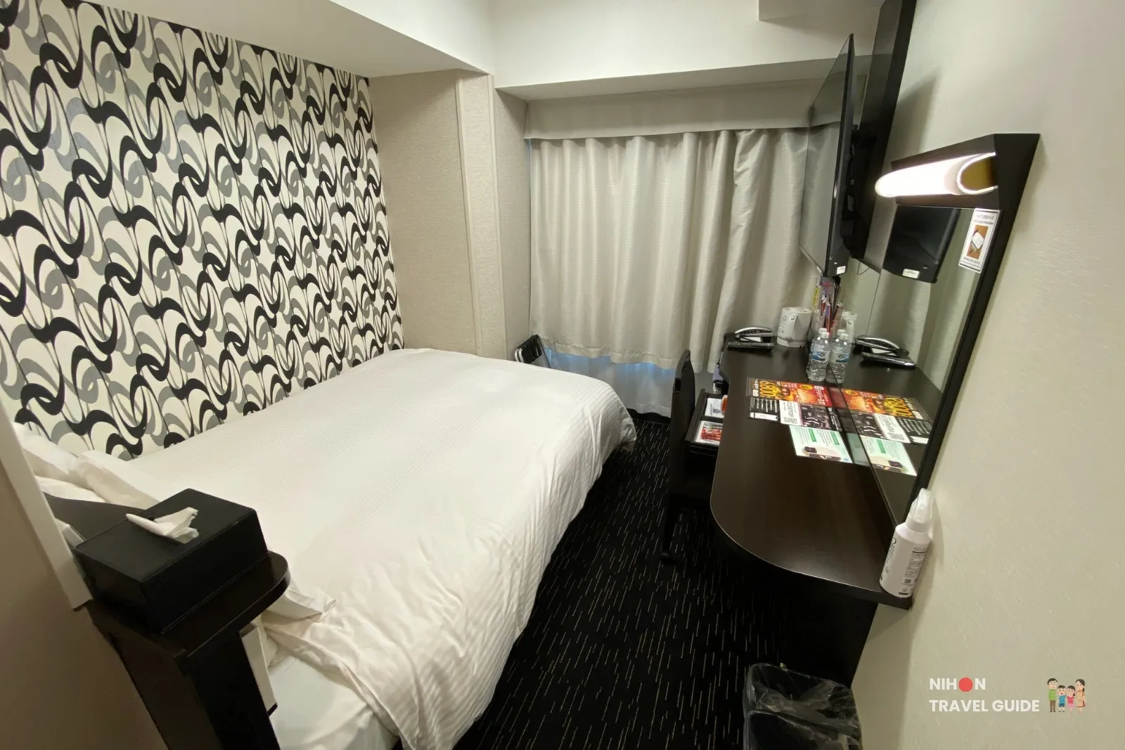 Central standard room at APA Hotel Hakata Eki Chikushiguchi showing the bed, window, wall-mounted TV, and writing desk.