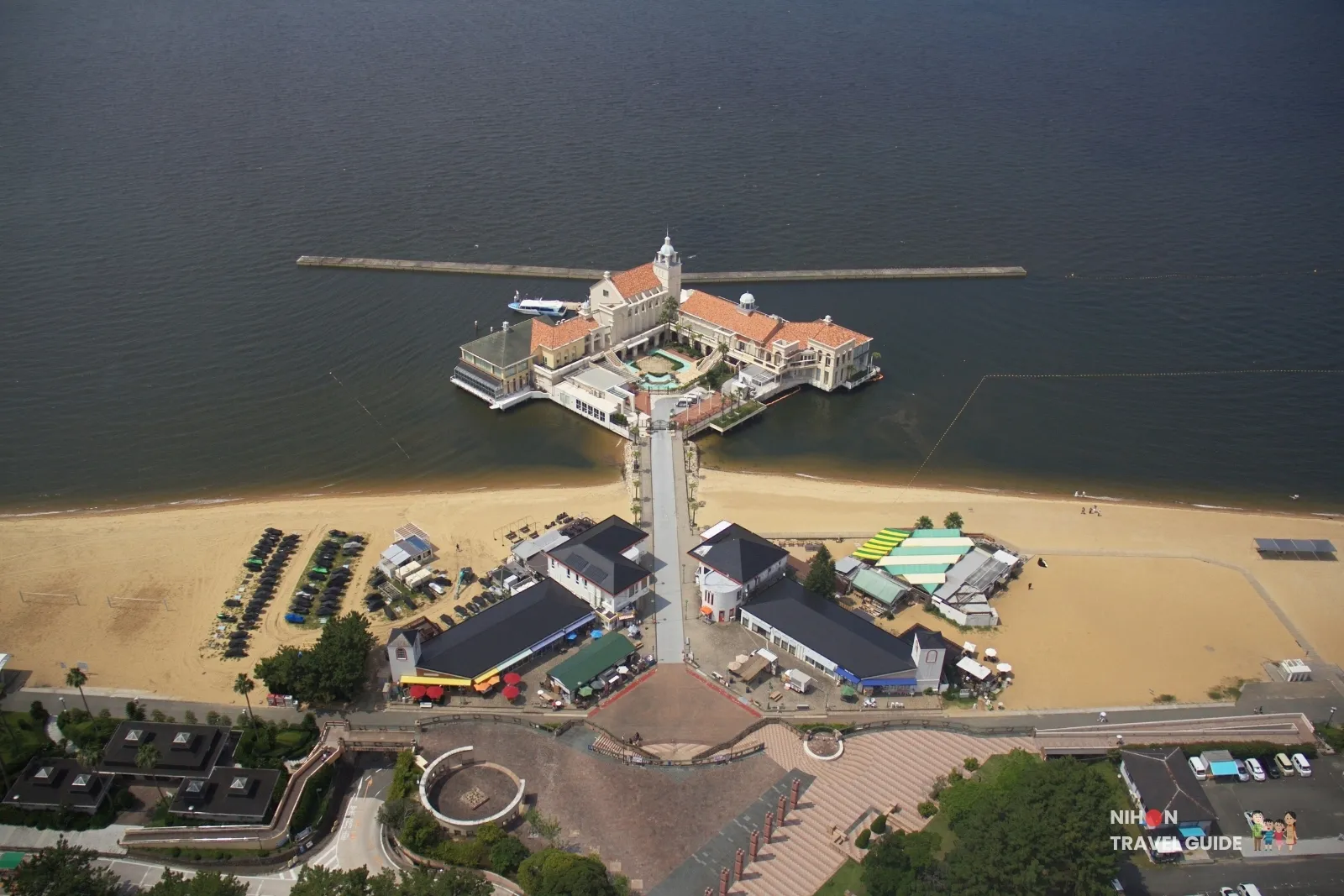 Looking down from Fukuoka Tower on Momochi Seaside Park’s sandy beach, seaside shops, and the Marizon pier stretching into Hakata Bay.
