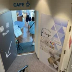 Entrance to Sky Cafe & Dining Refuge on Fukuoka Tower observation 2F, marked Cafe with a one-way route sign.